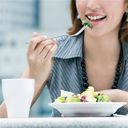 Close-up of a young woman eating salad Stock Photo - Premium Royalty-Free, Code: 625-02932972