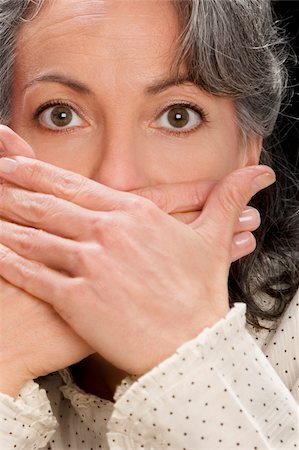 Portrait of a businesswoman covering mouth with hands Stock Photo - Premium Royalty-Free, Code: 625-02932987