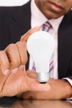 Close-up of a businessman holding a light bulb Stock Photo - Premium Royalty-Free, Code: 625-02932988
