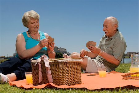 Senior couple playing cards at picnic Stock Photo - Premium Royalty-Free, Code: 625-02933167