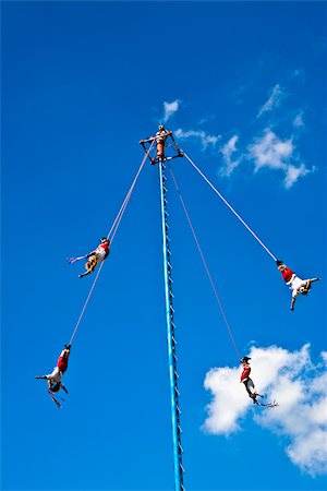 Low angle view of totonac voladores flying dancers flying from the pole, El Tajin, Veracruz, Mexico Stock Photo - Premium Royalty-Free, Code: 625-02933825