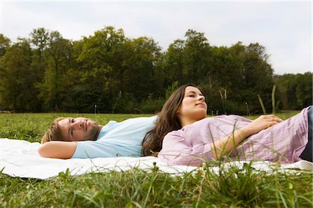 simsearch:628-07072151,k - Couple lying on blanket in grass, Munich, Bavaria, Germany Stock Photo - Premium Royalty-Free, Code: 628-05817260