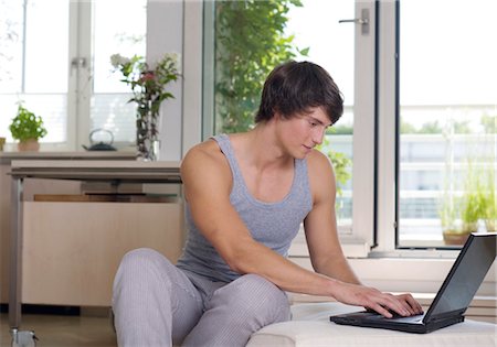 simsearch:628-07072884,k - Young man using laptop at home Stock Photo - Premium Royalty-Free, Code: 628-05817489