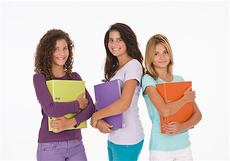 Three teenage girls holding files Stock Photo - Premium Royalty-Free, Code: 628-05817594