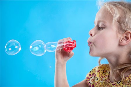 soap sud - Girl blowing soap bubbles Stock Photo - Premium Royalty-Free, Code: 628-05817696