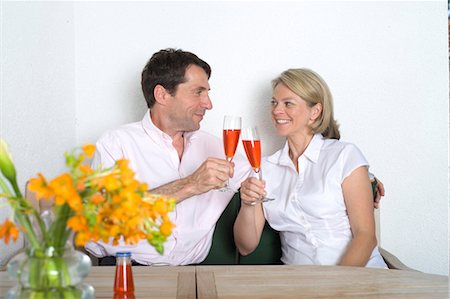 simsearch:628-07072151,k - Couple at home clinking champagne glasses, Munich, Bavaria, Germany Stock Photo - Premium Royalty-Free, Code: 628-05818110