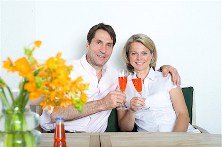 simsearch:628-07072151,k - Couple at home clinking champagne glasses, Munich, Bavaria, Germany Stock Photo - Premium Royalty-Free, Code: 628-05818125