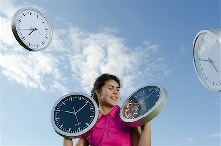 simsearch:614-06043612,k - Girl holding clocks outdoors Stock Photo - Premium Royalty-Free, Code: 628-07072130