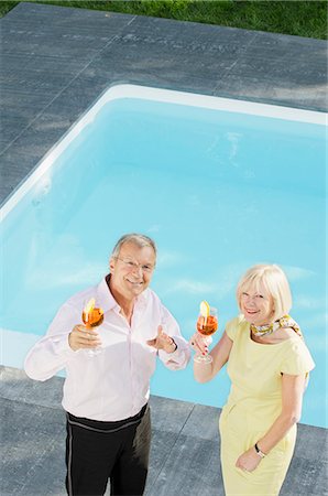 simsearch:649-06400798,k - Senior couple with cocktails by the poolside Photographie de stock - Premium Libres de Droits, Code: 628-07072172