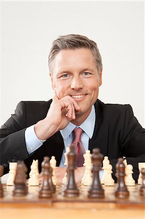 financial strategy - Businessman playing chess Stock Photo - Premium Royalty-Free, Code: 628-07072220