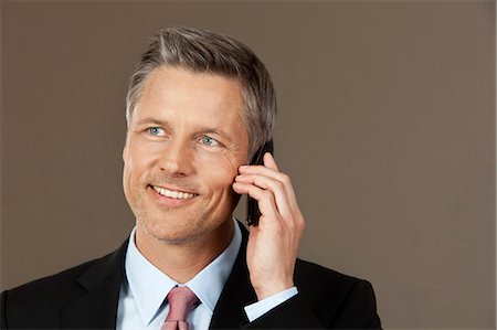 simsearch:6109-06685044,k - Smiling businessman on the phone Stock Photo - Premium Royalty-Free, Code: 628-07072234