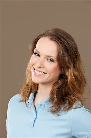 polo shirt - Smiling young woman in blue polo shirt Stock Photo - Premium Royalty-Free, Code: 628-07072242