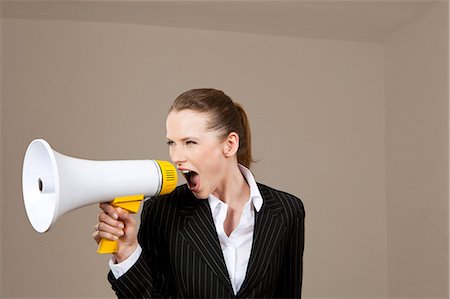 frustrated boss - Businesswoman screaming into megaphone Stock Photo - Premium Royalty-Free, Code: 628-07072257