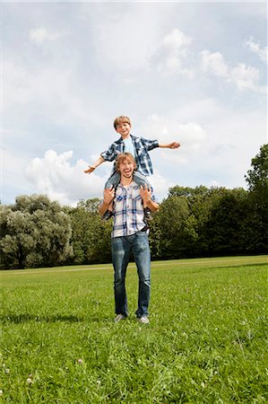 Father carrying son on shoulders outdoors Stock Photo - Premium Royalty-Free, Code: 628-07072286