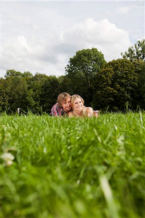 simsearch:628-07072151,k - Smiling young couple lying in meadow Stock Photo - Premium Royalty-Free, Code: 628-07072295