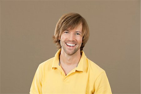 polo shirt - Happy man in yellow polo shirt Stock Photo - Premium Royalty-Free, Code: 628-07072320