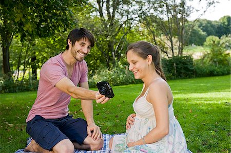 simsearch:628-07072151,k - Man taking photograph of pregnant woman in a park Stock Photo - Premium Royalty-Free, Code: 628-07072358