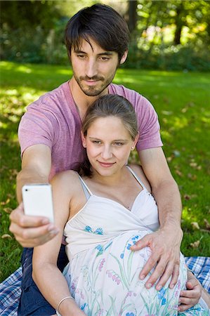simsearch:628-07072151,k - Man taking photograph of pregnant woman in a park Stock Photo - Premium Royalty-Free, Code: 628-07072351