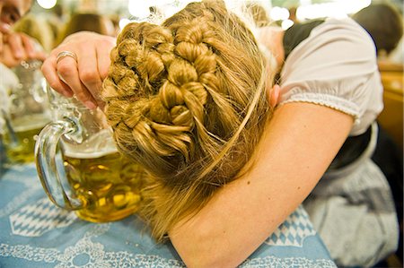 drinking beer - Exhausted woman with beer mug on the Oktoberfest in Munich, Bavaria, Germany Stock Photo - Premium Royalty-Free, Code: 628-07072366