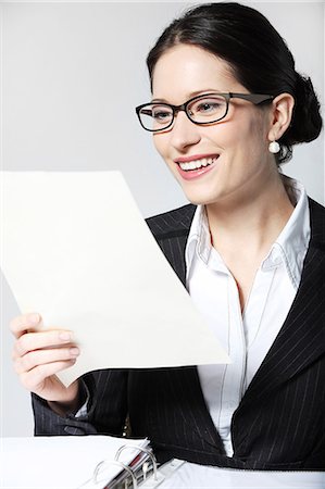 simsearch:628-07072621,k - Smiling businesswoman reading document Stock Photo - Premium Royalty-Free, Code: 628-07072425