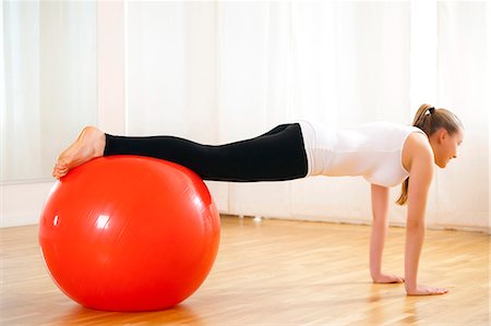 Teenage girl exercising with fitness ball Stock Photo - Premium Royalty-Free, Code: 628-07072474