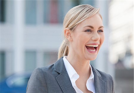 simsearch:628-07072621,k - Laughing blond businesswoman outdoors Stock Photo - Premium Royalty-Free, Code: 628-07072529