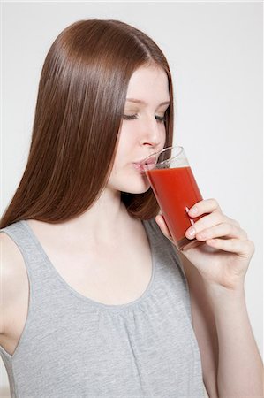 simsearch:628-05817544,k - Brunette young woman drinking tomato juice Stock Photo - Premium Royalty-Free, Code: 628-07072558