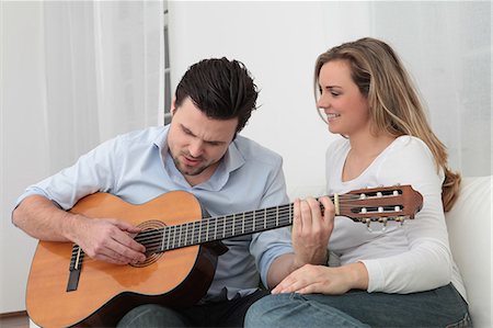 simsearch:628-07072734,k - Man playing guitar to woman on couch Stock Photo - Premium Royalty-Free, Code: 628-07072735