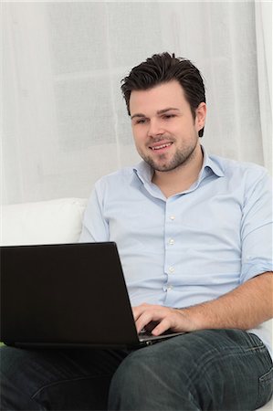 simsearch:628-07072884,k - Man using laptop on couch Stock Photo - Premium Royalty-Free, Code: 628-07072737