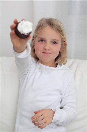 Girl eating chocolate marshmallow Stock Photo - Premium Royalty-Free, Code: 628-07072755