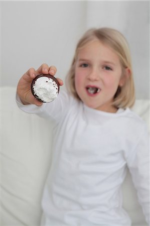 Girl eating chocolate marshmallow Stock Photo - Premium Royalty-Free, Code: 628-07072756