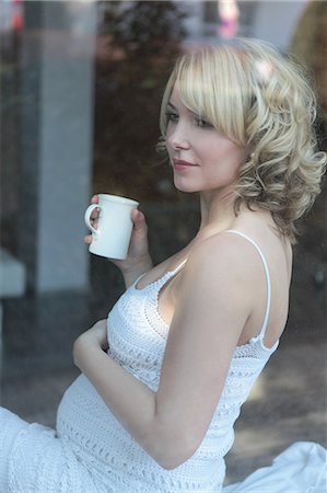 pregnant stomach - Pregnant woman holding cup of coffee Stock Photo - Premium Royalty-Free, Code: 628-07072874