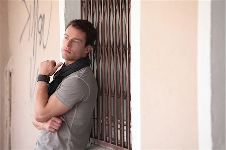 Brunette man in T-shirt and scarf outdoors Stock Photo - Premium Royalty-Free, Code: 628-07072908