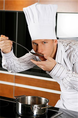 Cook in kitchen tasting food Stock Photo - Premium Royalty-Free, Code: 628-07072931