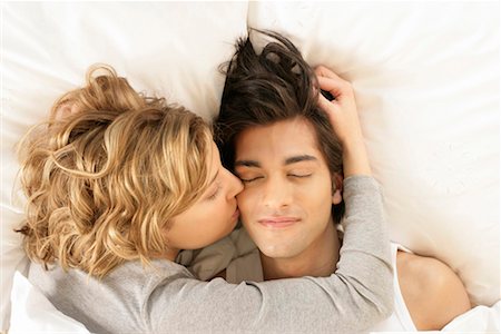 Young woman waking up man with kissing Stock Photo - Premium Royalty-Free, Code: 628-00918655