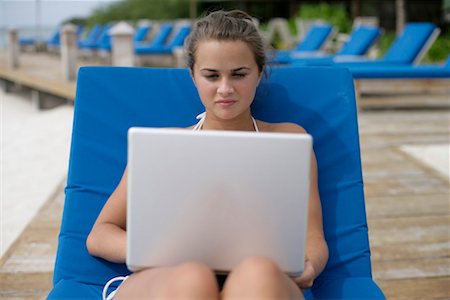 simsearch:628-00919176,k - Young girl sitting on a deck chair, using laptop Stock Photo - Premium Royalty-Free, Code: 628-00919198