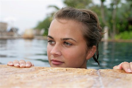 Young girl looking out of swimming pool Stock Photo - Premium Royalty-Free, Code: 628-00919228