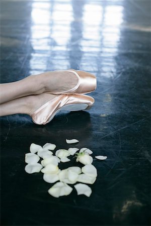 simsearch:628-00919318,k - Feet of a female ballet dancer wearing ballet shoes lying next to rose petals on the floor Stock Photo - Premium Royalty-Free, Code: 628-00919290
