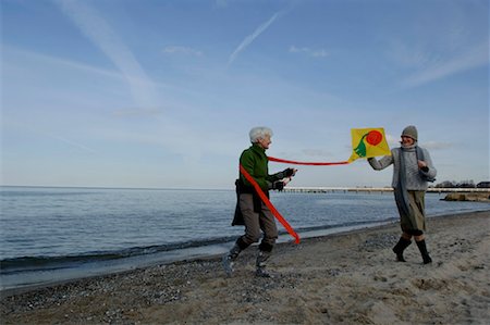 Two mature women flying a kite at Baltic Sea beach Stock Photo - Premium Royalty-Free, Code: 628-00920296