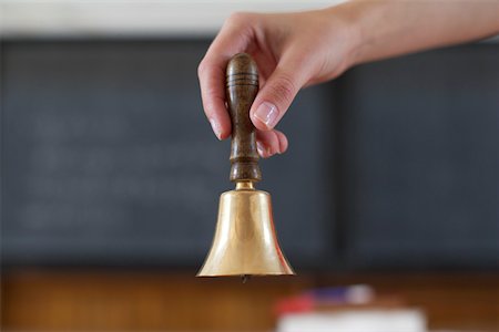 ring the bell - Hand holding a bell, close-up, selective focus Stock Photo - Premium Royalty-Free, Code: 628-01279476