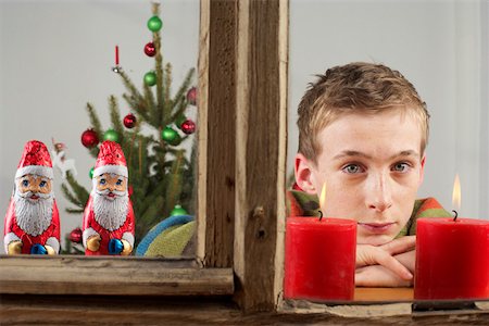 santa window - Wishful boy looking out of a window with Santa Claus chocolates Stock Photo - Premium Royalty-Free, Code: 628-01279720