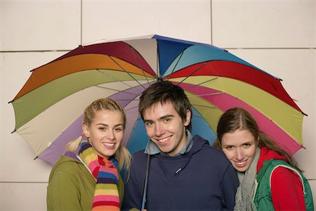 Group  of young people under an umbrella Stock Photo - Premium Royalty-Free, Code: 628-01495291