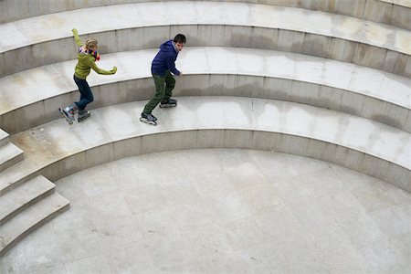 Young couple inline skating on step Stock Photo - Premium Royalty-Free, Code: 628-01495310