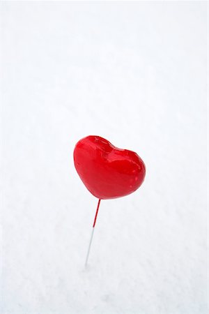 picture of a red lollipop - Heart-shaped lollipop in snow Stock Photo - Premium Royalty-Free, Code: 628-01495397
