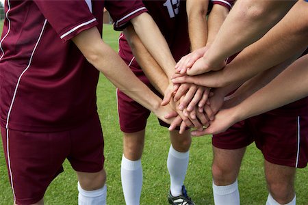 football team - Kickers putting hands together Stock Photo - Premium Royalty-Free, Code: 628-01586498