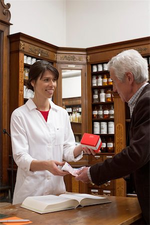 simsearch:400-04106195,k - Customer paying drugs in a pharmacy Stock Photo - Premium Royalty-Free, Code: 628-01586608