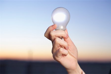 Businesswoman holding an electric bulb, close-up hand Stock Photo - Premium Royalty-Free, Code: 628-01639117