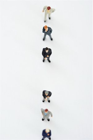 Businessmen figurines standing in a row Stock Photo - Premium Royalty-Free, Code: 628-01712179