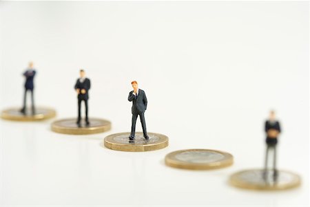 Businessmen figurines standing on one Euro coins Stock Photo - Premium Royalty-Free, Code: 628-01712237