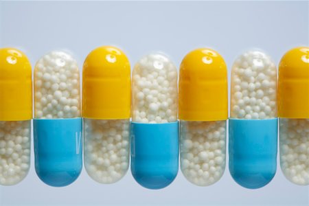 Blue and yellow capsules in a row Stock Photo - Premium Royalty-Free, Code: 628-01836763